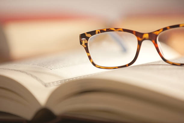 istock Glasses are laying on a book 530434809