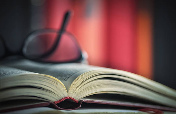 Glasses are laying on a book