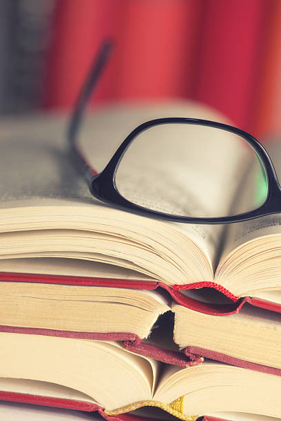 istock Glasses are laying on a book 530435473