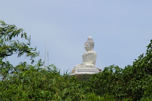 View of the Big Budha of Phuket throught the trees