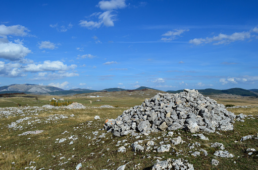 Mountain landscape with big pile of rocks in foreground