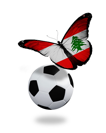 Concept - butterfly with  Lebanese flag flying near the ball, like football team playing