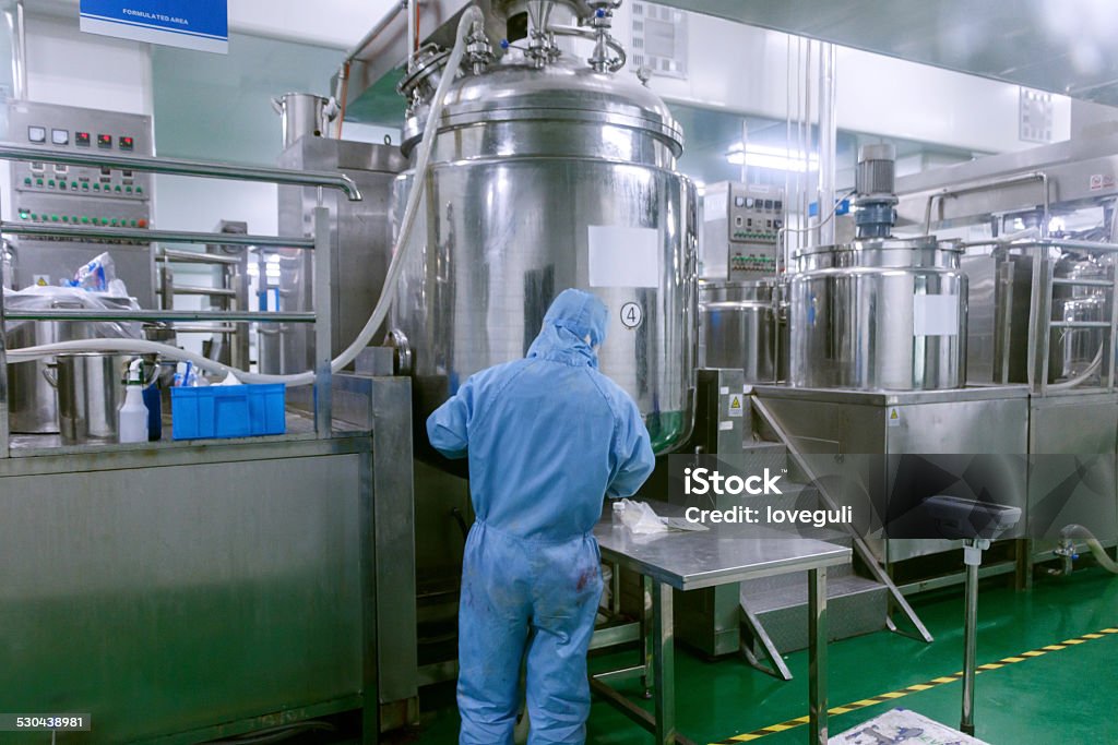 Technician check manufacture equipment and reactors in pharmacy factory Technician  check manufacture equipment and reactors in pharmacy factory Manufacturing Stock Photo