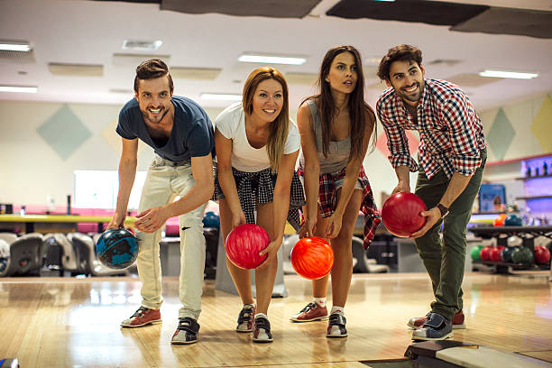 istock Smiling Friends Bowling Together 530440298