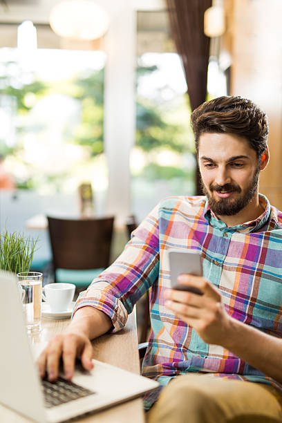 istock Happy businessman reading a text message on mobile phone 530441078