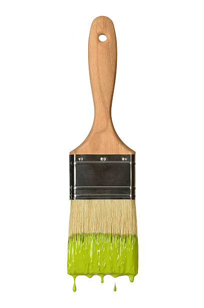 Paintbrush dripping green paint isolated over white background