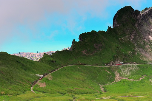 The train was passing slowly through a Ridge in Switzerland.