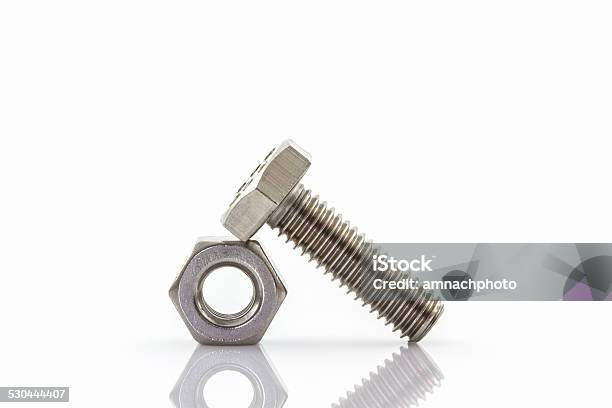 Metal Screw And Nuts On White Background Stock Photo - Download Image Now - Bolt - Fastener, Chrome, Close-up