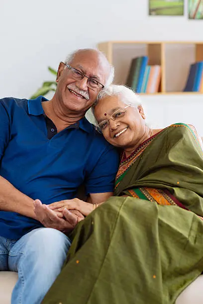 Portrait of senior Indian couple smiling and looking at the camera
