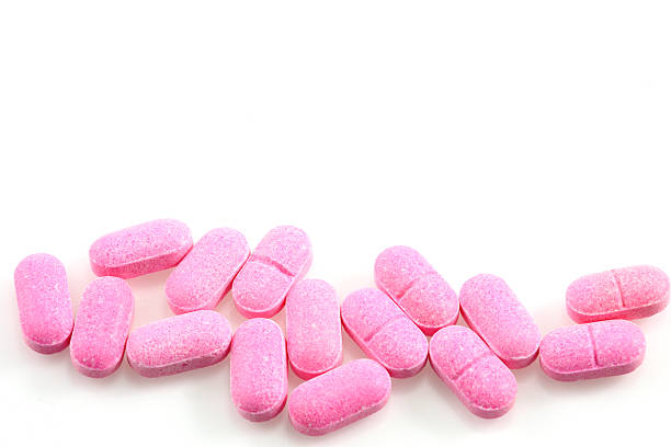 istock pink pills on a white background 530446017