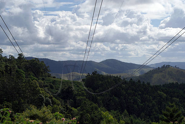 istock Overhead power lines cut a path through a lush valley 530446707