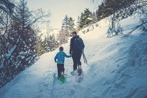 Father and Son Snowshoeing stock photo
