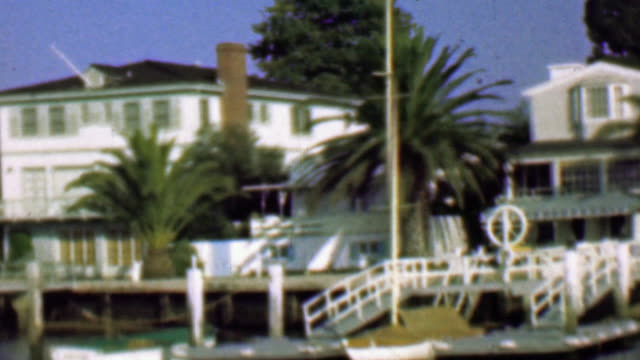 1958: Wealthy waterfront residential homes private docks boats.