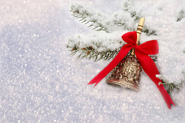 Christmas Red Bell hanging on  snow-covered fir branch