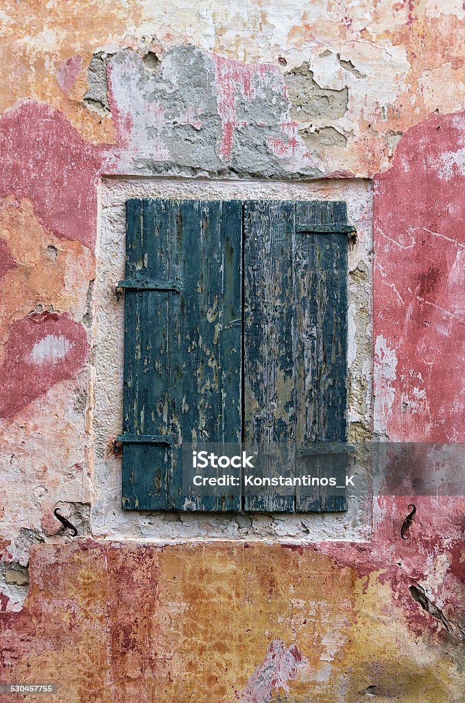 Closed shutters in Paxoi island, Greece Closed shutters on a window of an old building in Paxoi island, Greece Abandoned Stock Photo