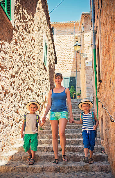 istock Mother with sons visiting mediterranean town. 530459993