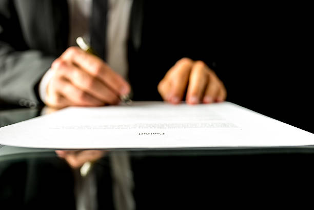 istock Businessman signing a document with focus to the text Contract 530467063