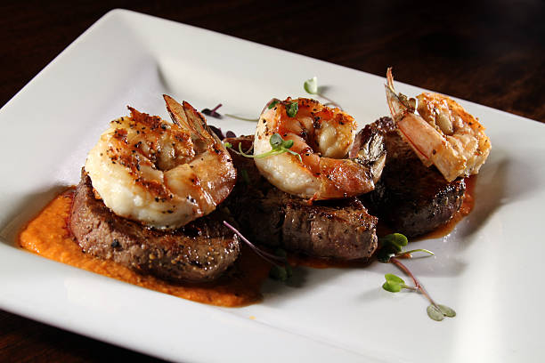 gourmet de surf and turf - surf and turf prepared shrimp steak grilled fotografías e imágenes de stock