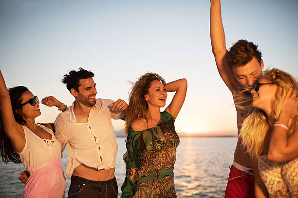 istock Friends on a beach party at sunset. 530467939