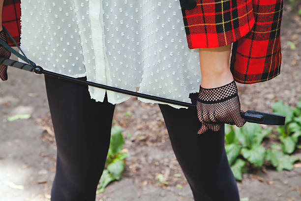 istock Horsewoman hand in fishnet glove holding stack for riding 530470337