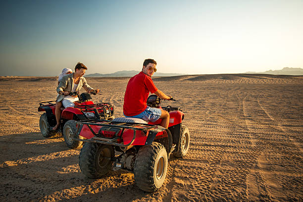 istock Driving quad bikes in the desert. 530470431