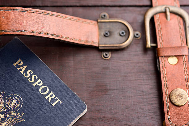 istock USA Passport Resting on Woodent Suitcase with Leather Handle 530477447