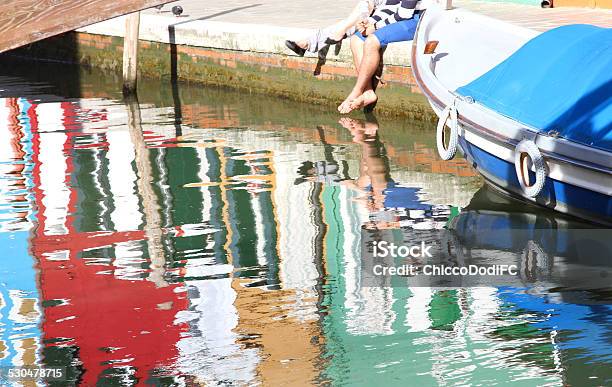Tourists With Barefoot Into The Water On The Burano Island Stock Photo - Download Image Now