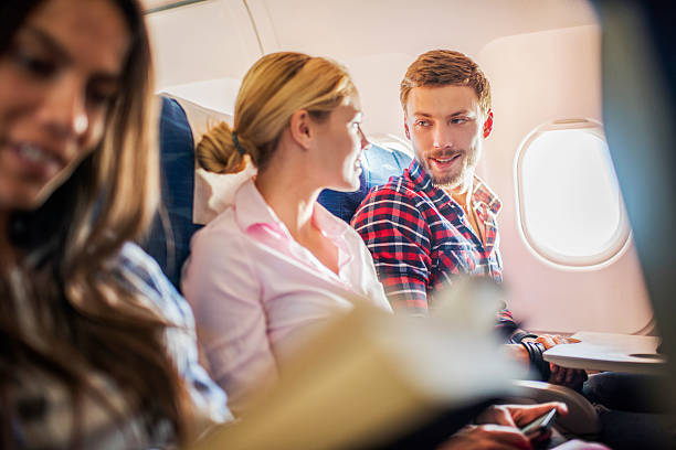 istock Young couple talking in airplane. 530478923