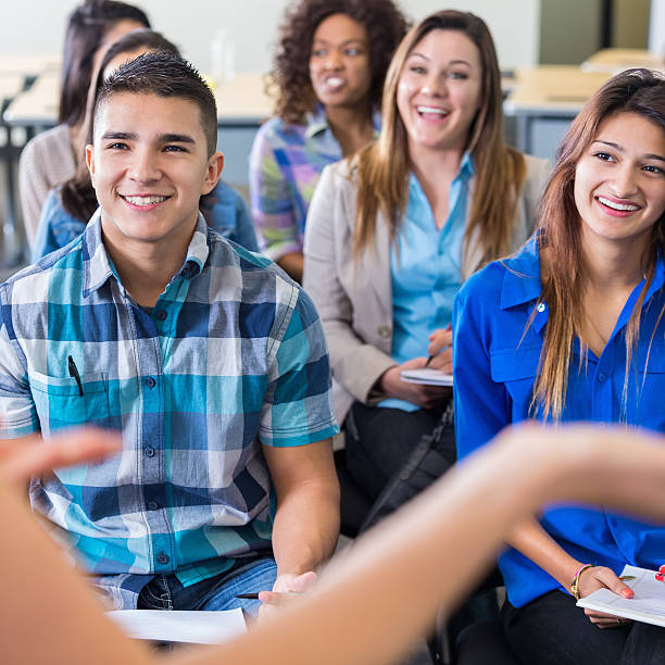 istock Diverse teens listening to speaker during presentation at school 530479437