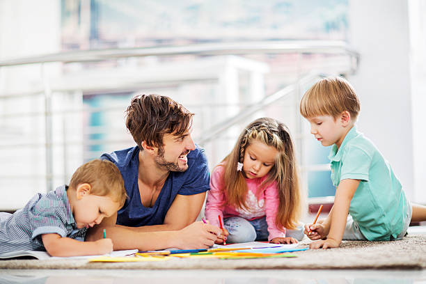 istock Father coloring with his children. 530480847