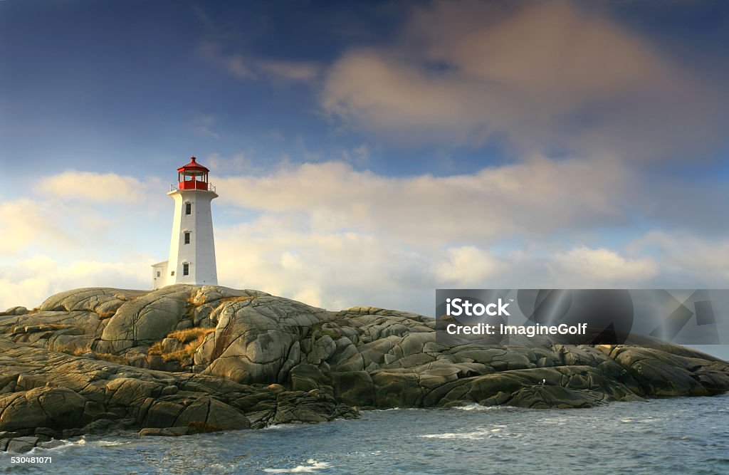 Lighthouse at Peggy's Cove The beautiful lighthouse at Peggy's Cove, Nova Scotia in dramatic morning light. This is one of the most famous lights in Canada and was also the scene of a tragic plane crash in the 90s. The water-worn rocks and dramatic lighthouse clutching the rocks are classic Canadiana. Thousands of people take the short drive from Halifax to visit Peggy's Cove, a classic fishing village, each year.  Halifax Regional Municipality - Nova Scotia Stock Photo