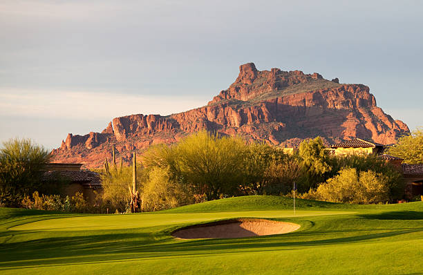 Desert Golf Course in Arizona A beautiful desert golf course in Arizona, United States. A gorgeous golf course scenic image in the desert of Arizona. This region is one of the most popular golf destinations in the United States. Snowbirds come from all over the world, especially northern states and Canada, to experience the warm dry climate of the desert in winter. Nobody is in the image. Usary Mountains near Mesa are in the background.  mesa photos stock pictures, royalty-free photos & images
