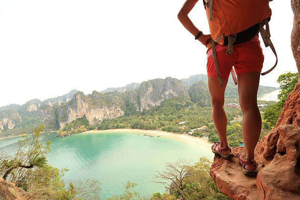 istock young woman backpacker hiking at seaside mountain cliff 530483390