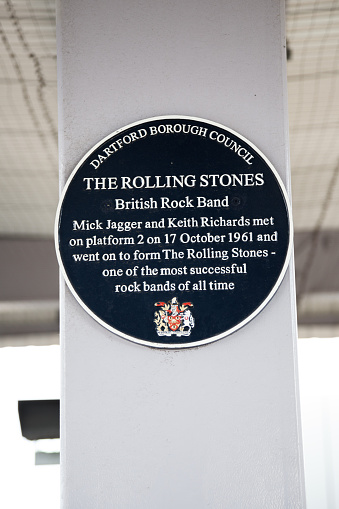 Dartford, United Kingdom  - May 7, 2016:  A blue plaque can be seen in Dartford station celebrating the meeting between two founder members of the 'Rolling Stones' rock group. Blue Plaques are used to commemorate a link between particular places and significant historical people and events. The scheme is currently administered by the English Heritage organisation. This plaque relates to a meeting in October 1961 between Mick Jagger and Keith Richards.