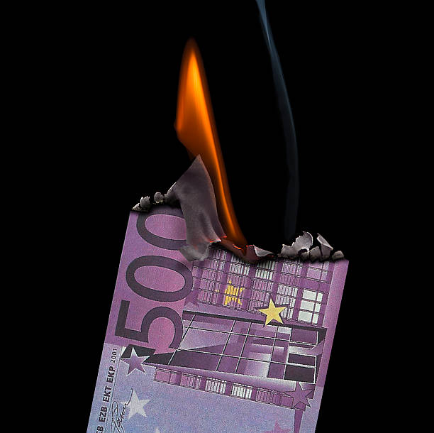 istock 500 Euro Banknote on fire set on a  black background. 530484675