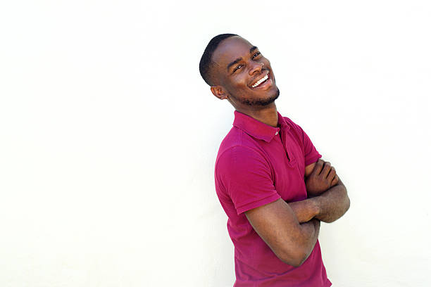 istock Smiling young african man standing with arms crossed 530487120