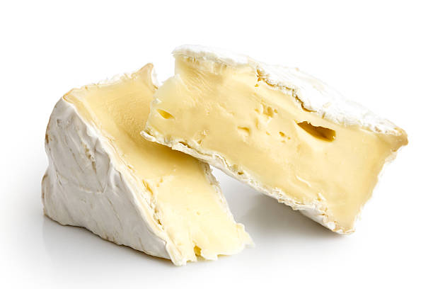 White mould cheese. Two pieces of cut white mould cheese isolated on white. brie stock pictures, royalty-free photos & images