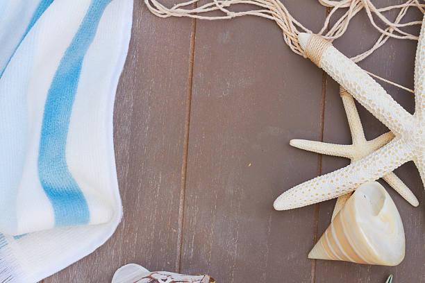istock starfish and sea shells on wooden board 530487978