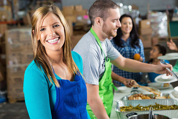 istock Volunteers serves food at soup kitchen 530488382