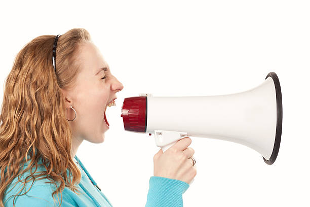 istock Teenager yells through megaphone 530488534