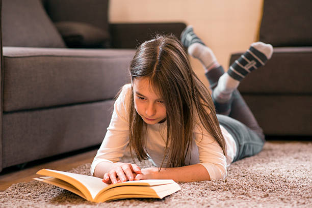 istock Beautiful Little Girl Reading a Book 530490380