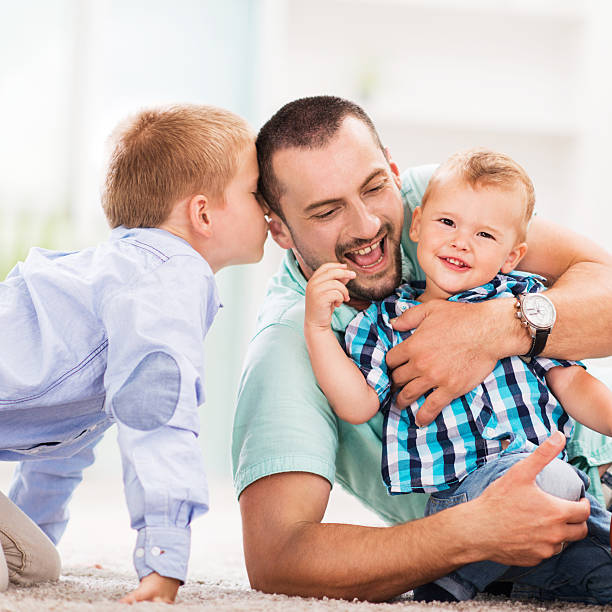 istock Cheerful father and sons. 530491593