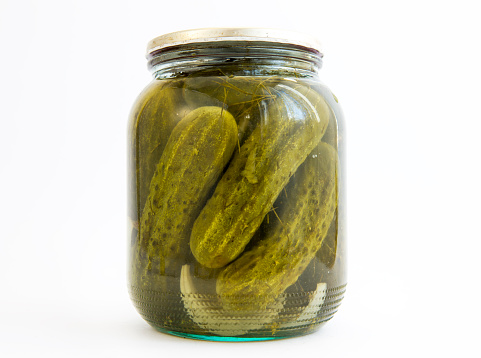 Pickles in a jar isolated on white.