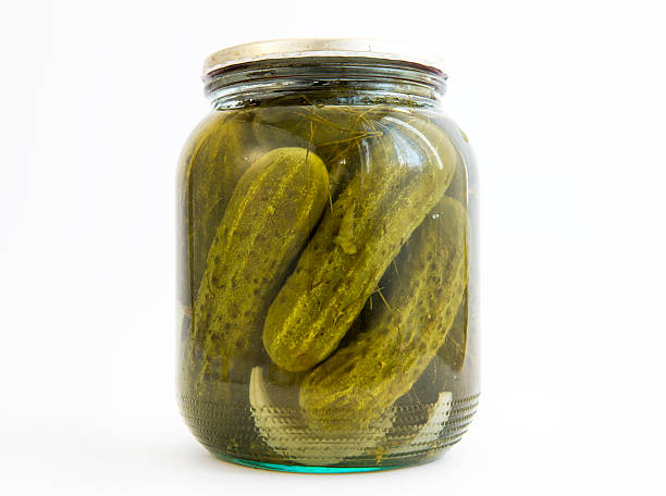 Pickles jar Pickles in a jar isolated on white. pickled stock pictures, royalty-free photos & images