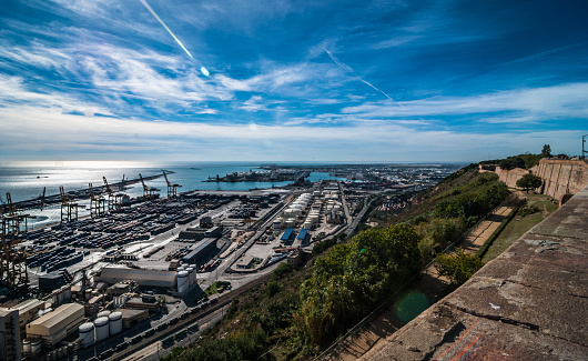 Beautiful Blue Commerce in the Ports of Barcelona, Spain.  Adriatic sea and the Coast of Spain,  A view of the industrial shipping ports on a blue-sky sunny day.