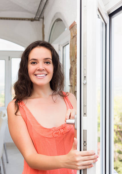 istock Brunette staying near plastic windows 530494321