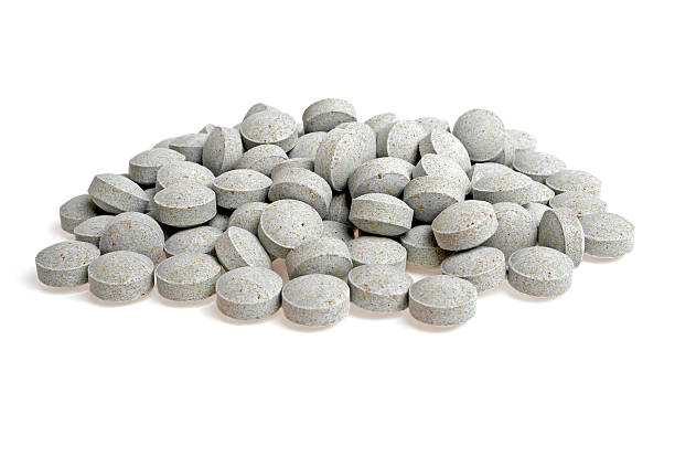 istock Natural herbal pills isolated on white background 530496005