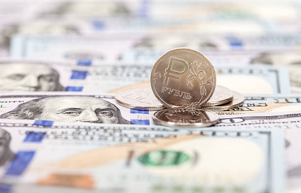istock Russian rubles coins over dollars banknotes 530497390