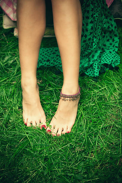 istock barefoot woman feet on grass 530497734