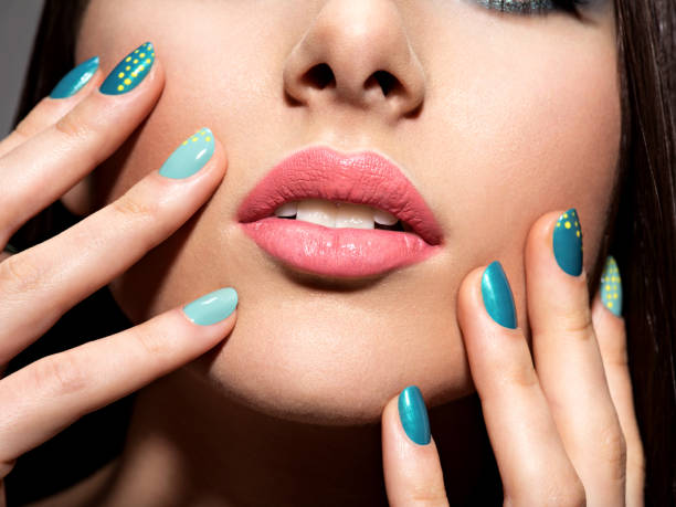 istock Female fingers with motton blue color 530499122